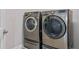Laundry room with two front loading washing machines in stainless steel and white wall color at 8852 Sperry St, Orlando, FL 32827