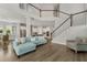 Open floor plan with living room featuring a modern staircase and a view of the eat-in kitchen at 8852 Sperry St, Orlando, FL 32827