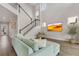 Bright living room boasts wood floors, a modern staircase, and a comfortable light blue couch at 8852 Sperry St, Orlando, FL 32827