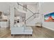Bright and open living room featuring high ceilings, a staircase, and wood flooring at 8852 Sperry St, Orlando, FL 32827