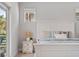 Cozy main bedroom featuring a private balcony, wood nightstand and neutral tones at 8852 Sperry St, Orlando, FL 32827