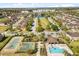 Aerial view showcasing an amenity center, lake, and community green space within a well-kept residential area at 10608 Savannah Plantation Ct, Orlando, FL 32832