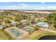 Aerial view showing amenities, tennis and basketball courts, pool, playground, and green space in a community at 10608 Savannah Plantation Ct, Orlando, FL 32832