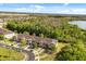 Aerial view of community, showcasing manicured lawns and lake views at 10608 Savannah Plantation Ct, Orlando, FL 32832