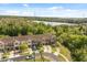 Aerial view of townhomes near lush landscaping, lake and neighborhood amenities at 10608 Savannah Plantation Ct, Orlando, FL 32832