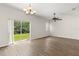 Sunlit living room featuring sliding glass doors that open to a green and spacious backyard at 10608 Savannah Plantation Ct, Orlando, FL 32832
