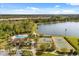 Aerial view of resort-style community amenities featuring a pool, lake, tennis courts, and playground at 10608 Savannah Plantation Ct, Orlando, FL 32832
