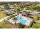 A beautiful aerial view of the community pool, close to tennis courts and playground for residents at 10608 Savannah Plantation Ct, Orlando, FL 32832