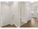 Well-lit hallway leading to a bathroom and bedroom, featuring modern flooring at 10608 Savannah Plantation Ct, Orlando, FL 32832