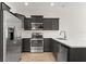 Contemporary kitchen featuring stainless steel appliances and dark cabinets with light countertops at 10608 Savannah Plantation Ct, Orlando, FL 32832