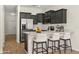 Modern kitchen with stainless steel appliances, quartz countertops, and breakfast bar seating at 10608 Savannah Plantation Ct, Orlando, FL 32832