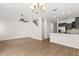 Open concept living area showcasing the kitchen and staircase, with hardwood flooring throughout at 10608 Savannah Plantation Ct, Orlando, FL 32832