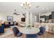 Bright living room with wood floors, modern furniture, and an open concept to the kitchen at 10608 Savannah Plantation Ct, Orlando, FL 32832