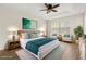 Serene main bedroom with tray ceiling, plush rug, and comfortable seating area at 10608 Savannah Plantation Ct, Orlando, FL 32832