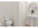 Bright powder room featuring pedestal sink, updated fixtures and tile flooring at 10608 Savannah Plantation Ct, Orlando, FL 32832