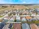 Expansive aerial view displays a community with homes featuring private screened-in pools at 130 Bloomingdale Dr, Davenport, FL 33897