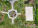 Bird's eye view of a serene park with volleyball court, walking paths and shady seating areas at 130 Bloomingdale Dr, Davenport, FL 33897
