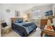 Comfortable bedroom is filled with natural light, complemented by stylish decor and furnishings at 130 Bloomingdale Dr, Davenport, FL 33897