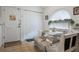 Charming breakfast nook features a cozy built-in bench with coffee-themed upholstery and natural light at 130 Bloomingdale Dr, Davenport, FL 33897