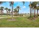 Community park featuring walking paths, green spaces, palm trees, and residential homes in the background at 130 Bloomingdale Dr, Davenport, FL 33897