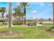 Park with grassy area, bench and walking path near a pond, offering a relaxing community space at 130 Bloomingdale Dr, Davenport, FL 33897