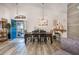 Open-concept dining room with modern lighting and a view of the entryway at 130 Bloomingdale Dr, Davenport, FL 33897