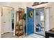Bright entryway with a blue door, decorative wreath, and view into the dining area at 130 Bloomingdale Dr, Davenport, FL 33897