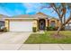 Charming single-story home with a well-manicured lawn and a two-car garage at 130 Bloomingdale Dr, Davenport, FL 33897