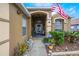 Inviting front porch with decorative plants and an American flag at 130 Bloomingdale Dr, Davenport, FL 33897