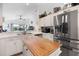 Open kitchen with white cabinetry, stainless steel appliances, and center island at 130 Bloomingdale Dr, Davenport, FL 33897