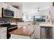 Bright kitchen featuring white cabinets and stainless steel appliances at 130 Bloomingdale Dr, Davenport, FL 33897
