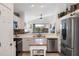Modern kitchen with stainless steel appliances and a center island at 130 Bloomingdale Dr, Davenport, FL 33897