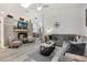 Bright living room with a decorative fireplace and sleek wood-look floors at 130 Bloomingdale Dr, Davenport, FL 33897
