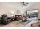 Cozy living room featuring a ceiling fan and sliding glass doors to the patio at 130 Bloomingdale Dr, Davenport, FL 33897