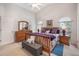 Bright main bedroom with vaulted ceiling, a sleigh bed, and a comfortable sitting area at 130 Bloomingdale Dr, Davenport, FL 33897
