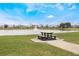Charming picnic area with a table overlooking a serene community lake with a fountain and lush green surroundings at 130 Bloomingdale Dr, Davenport, FL 33897