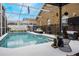 Screened-in pool with plenty of patio space and well-kept landscaping at 130 Bloomingdale Dr, Davenport, FL 33897