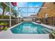Private screened pool with tropical landscaping and ample deck space at 130 Bloomingdale Dr, Davenport, FL 33897