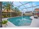 Screened-in pool with a patio and tropical landscaping creates a relaxing outdoor oasis at 130 Bloomingdale Dr, Davenport, FL 33897