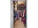 Spacious walk-in closet with custom shelving and ample storage space for clothes and accessories at 130 Bloomingdale Dr, Davenport, FL 33897