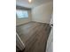 Bedroom with wood-look floors and a large window provides natural light at 1309 Heritage Commons Dr, Winter Springs, FL 32708