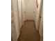Hallway featuring neutral carpeting and multiple closet doors, providing ample storage solutions at 1309 Heritage Commons Dr, Winter Springs, FL 32708