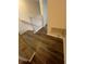 Hallway with wood-look flooring and white trim leads to different areas of the home at 1309 Heritage Commons Dr, Winter Springs, FL 32708