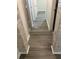 Hallway with wood-look flooring accented by decorative columns leads to rooms at 1309 Heritage Commons Dr, Winter Springs, FL 32708