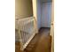 Upstairs hallway with carpet flooring, white railings, and closet doors at 1309 Heritage Commons Dr, Winter Springs, FL 32708