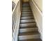 Stairway with modern wood-look flooring and white railing leads to the upper level at 1309 Heritage Commons Dr, Winter Springs, FL 32708