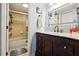 Bathroom with a marble topped vanity, dark wood cabinets, shower and toilet at 145 N Halifax Ave # 211, Daytona Beach, FL 32118