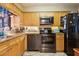 Functional kitchen featuring granite countertops, stainless appliances and ample cabinet space at 145 N Halifax Ave # 211, Daytona Beach, FL 32118