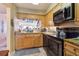 Well-lit kitchen with stainless steel appliances, ample counter space and light wood cabinetry at 145 N Halifax Ave # 211, Daytona Beach, FL 32118