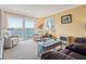 Cozy living room featuring reclining chairs, an electric fireplace and water views at 145 N Halifax Ave # 211, Daytona Beach, FL 32118
